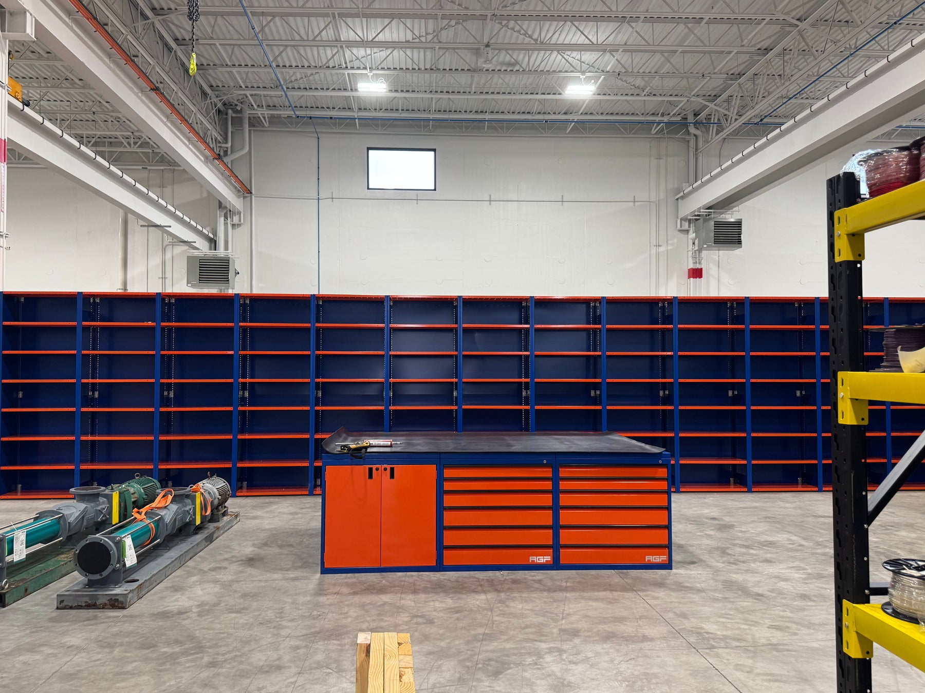 Industrial tool storage area with shelving, cabinets and a work surface