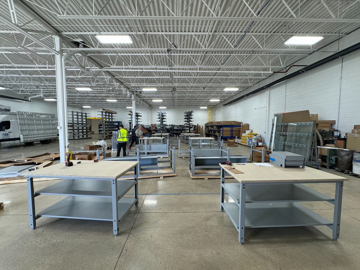 Work tables being set up in a warehouse work area